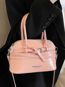 Elegant pink shell-shaped crossbody handbag with glossy finish and silver buckle details