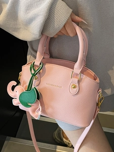 Pink lychee grain leather bucket bag with cute elephant charm and thin strap