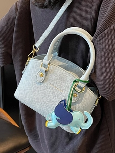 Pale blue lychee grain leather bucket bag with elephant charm and gold hardware