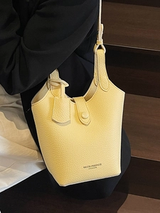 Chic pale yellow lychee texture bucket bag for women with elegant crossbody strap