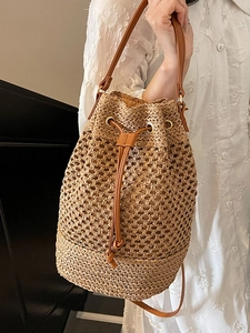 Fashionable woven straw bucket bag with hollow mesh design and leather drawstring strap