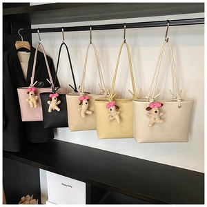 Detail of minimalist faux leather tote bags in five colors with cute puppy charms