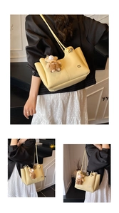Detail of light yellow lychee textured leather tote bag with a cute bear plush charm