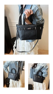 Détail du sac seau en cuir noir grainé avec fermoir rotatif argenté et bandoulière