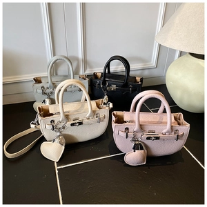 Litchi texture half-round crossbody bags in four colors with heart-shaped pendants