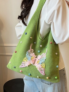 Green knit tote bag with colorful beads and butterfly floral embroidery for beach vacation