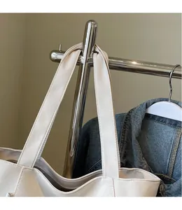 Detailed close-up of thick canvas tote bag wide strap with neat reinforced stitching