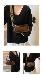 Détail du sac bandoulière marron vintage montrant la large sangle tissée et la lanière cuir