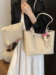 Chic off-white faux leather tote bag set with plush puppy charm and rope handles