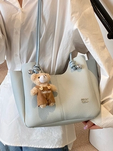 Light blue lychee texture tote bag with cute bear charm and thin shoulder strap