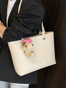 Minimalist beige tote bag in lychee pattern leather with cute dog plush pendant charm