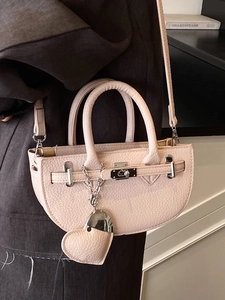 Chic pink semi-circular crossbody bag with lychee texture and Kelly-style lock