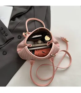 Detailed top view of pink woven texture bucket bag showing its spacious inner compartment