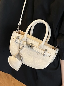 Elegant off-white lychee pattern semi-circle handbag with silver hardware and heart charm