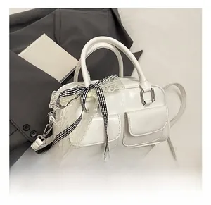 Detailed close-up of the white bow-knot bowling bag with lace and plaid decorative elements