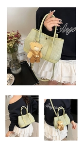 Detail of light green woven bucket bag with metal buckle and cute bear pendant accessory