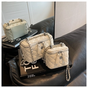 Three-piece set of white quilted chain vanity bags with camellia flower metal zipper detail