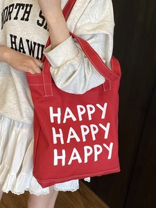 Large red canvas tote bag with white HAPPY print and contrast stitching for daily commute
