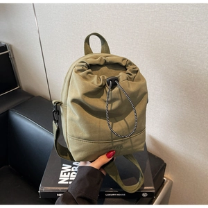 Detail of army green nylon drawstring mini bag showing durable fabric and black buckle