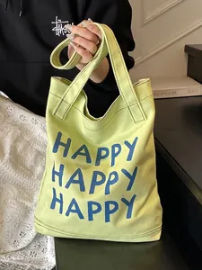 Avocado green canvas tote bag with blue HAPPY art lettering for daily commute