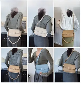 Detail of minimalist leather crossbody bags with lychee texture and braided strap decoration