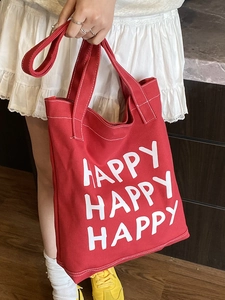 Large red canvas tote bag with white HAPPY lettering for daily commuting and student use