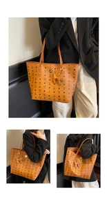 Detail showing high-capacity tote bag with classic print, metal logo and dog charm