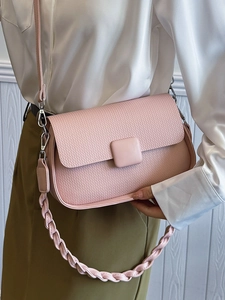 Pink minimalist crossbody square bag with woven flap and decorative braided top handle