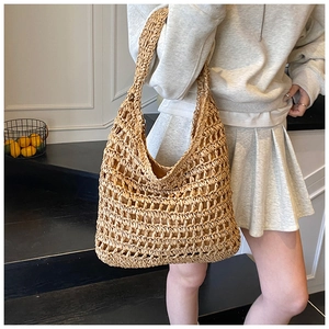 Detailed view of woven hollow grid texture on summer straw tote bag for beach vacation
