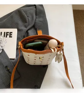 Interior view of the printed bucket bag showing capacity for phone and umbrella