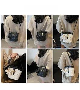 Detailed views of printed bucket bags in black and beige with vintage patterns