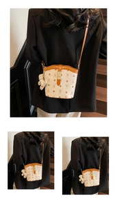 Detail view of stylish printed bucket bag with brown bear patterns and leather strap