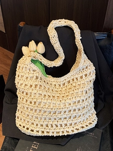Minimalist beige woven straw tote bag with cutout crochet design for beach holidays