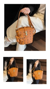 Three-way view of a brown pebbled bucket bag with monogram print and golden metal buckle