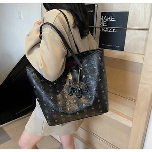 Detail of printed large capacity tote bag with bear pattern and elephant charm