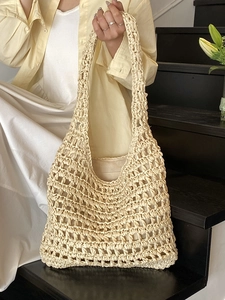Minimalist cream woven straw tote bag with hollow texture and inner lining for beach