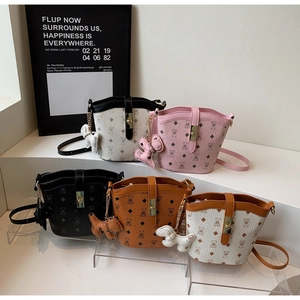 Detail view of five mini bucket bags with vintage bear print and puppy charms