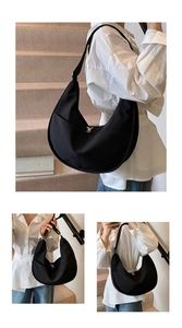 Detail view of black nylon crescent bag with adjustable strap and silver metal zipper