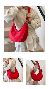Detail of red crescent dumpling bag in durable canvas with wide adjustable strap