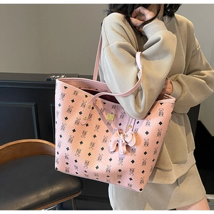 Detailed macro view of pink printed tote bag featuring leather texture and bear pattern