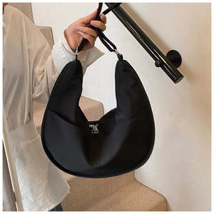 Close-up of black half-moon hobo bag showing high-quality nylon fabric and silver zipper