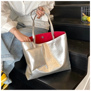 Silver large tote bag with vibrant red lining and a matching small zipper pouch