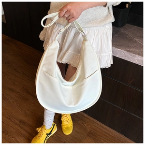 Detail of white half-moon shoulder bag in soft synthetic leather with smooth stitching