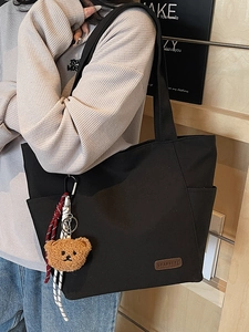Minimalist canvas tote bag for women with bear charm and large capacity for commuting