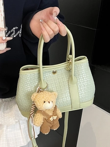 Light green woven texture bucket bag with cute bear charm and thin shoulder strap