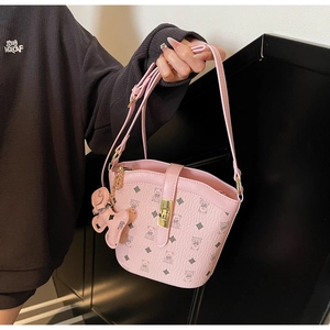 Pink bucket bag with classic bear pattern, textured leather and gold-tone twist lock