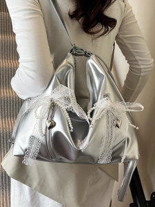 Metallic silver ballet-style tote bag with white lace bows and pearl charms