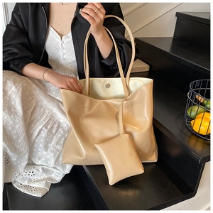 Detail of beige tote bag with glossy wrinkled texture and matching interior pouch