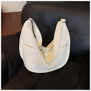 Detail showing the ivory crescent hobo bag side pocket and adjustable wide strap
