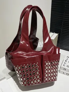 Dark red patent leather punk tote bag with silver studs and sleek modern design